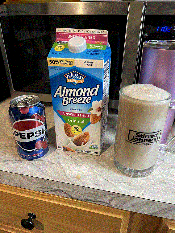 photo of a can of cherry pepsi next to a carton of unsweetened original "almond breeze" almond milk, to the right of them both is the cursed abomination that is the cherry almond pilk it made