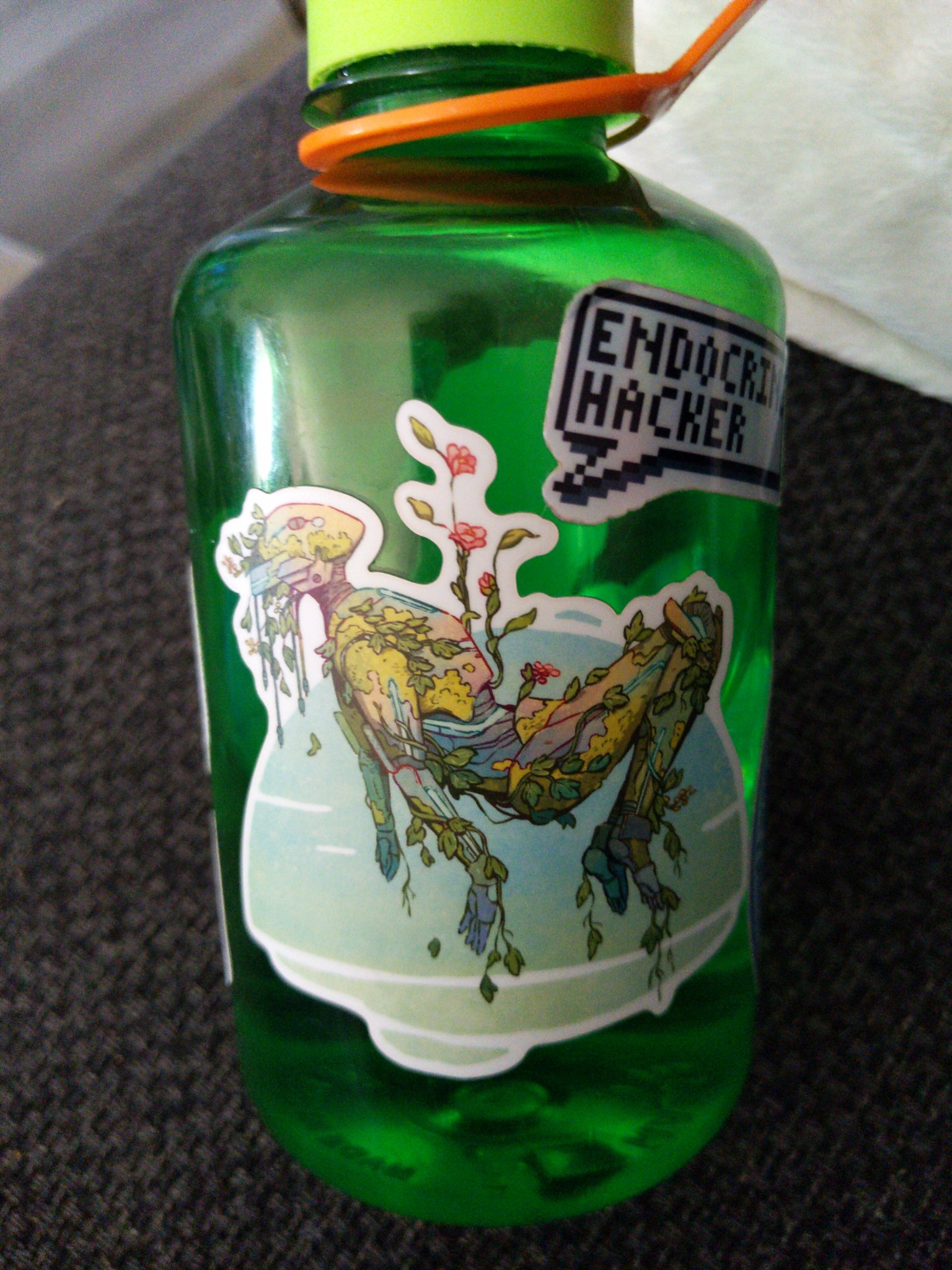 a water bottle with a floating plant bot sticker.