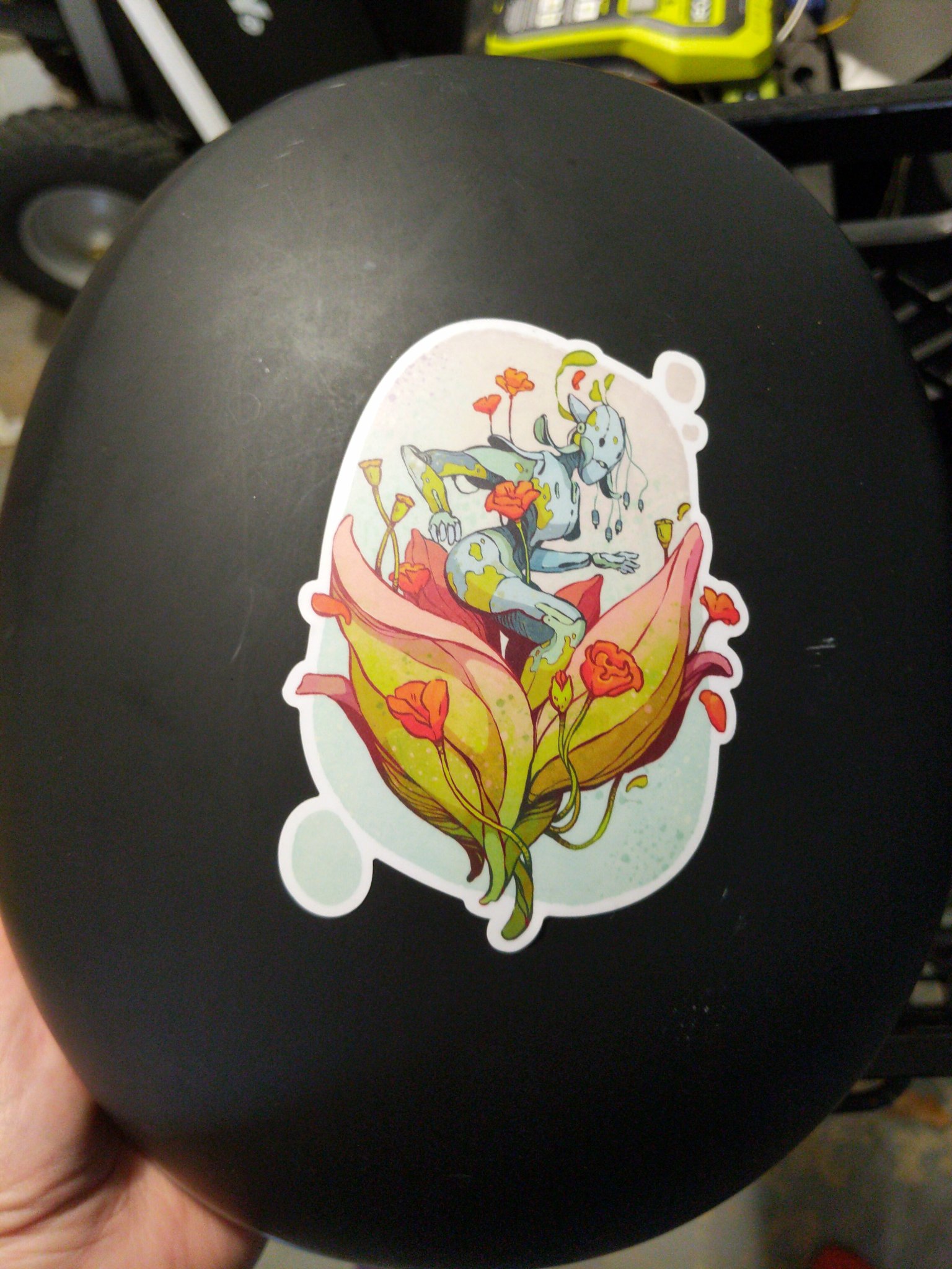 a bike helmet with a rose bot sticker.