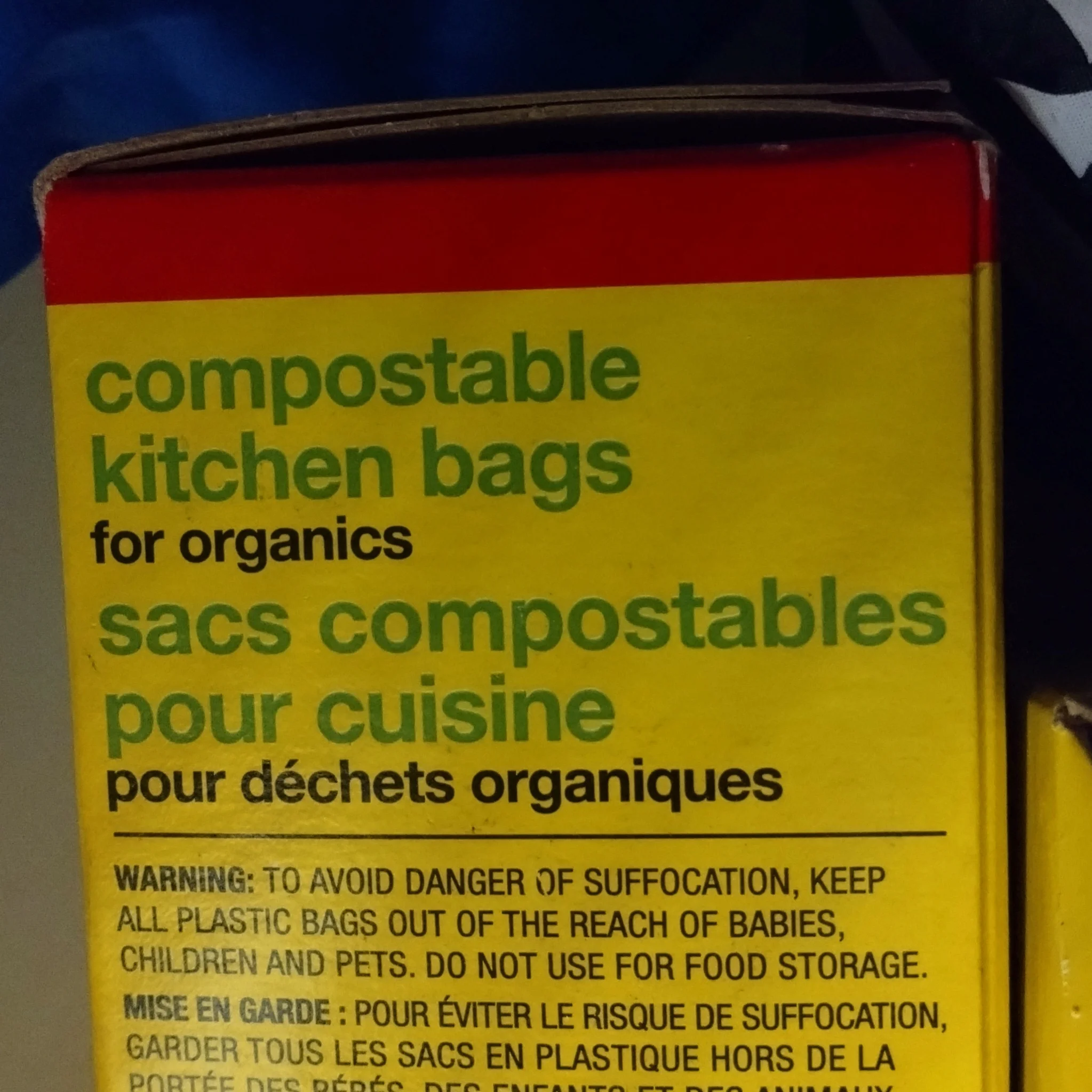 A cardboard box of "compostable kitchen bags for organics". it is mostly yellow, like most "no name" brand items.