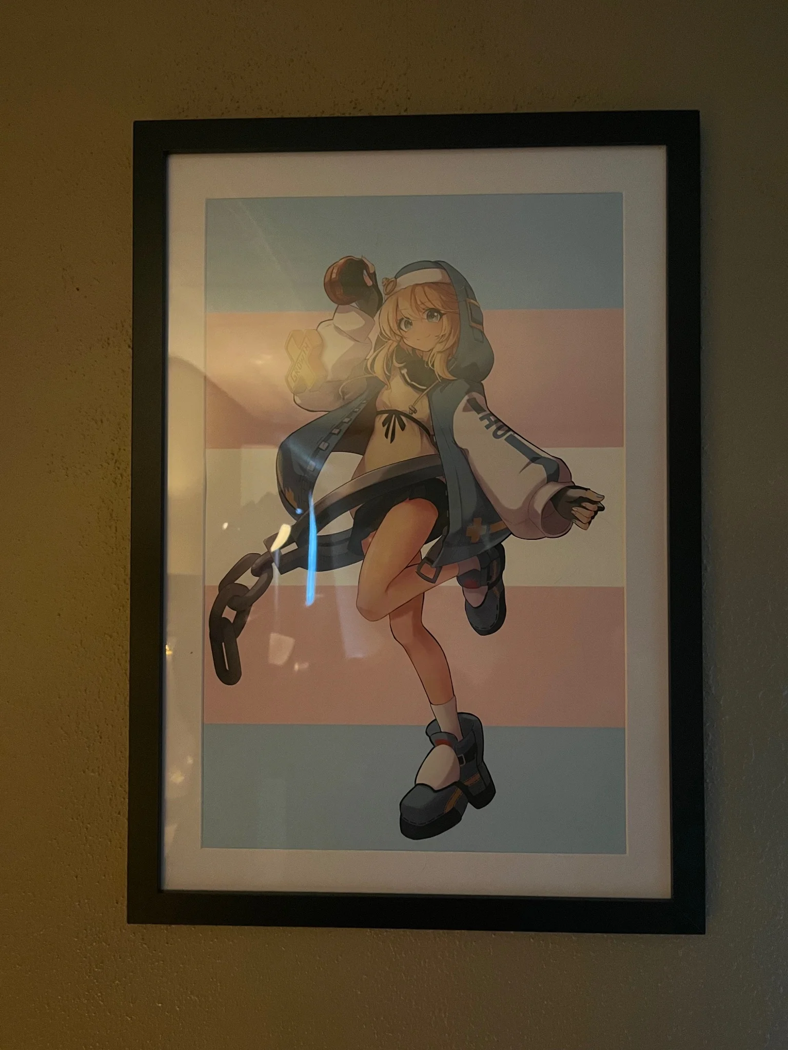 framed photo of bridget from guilty gear in front of a trans pride flag