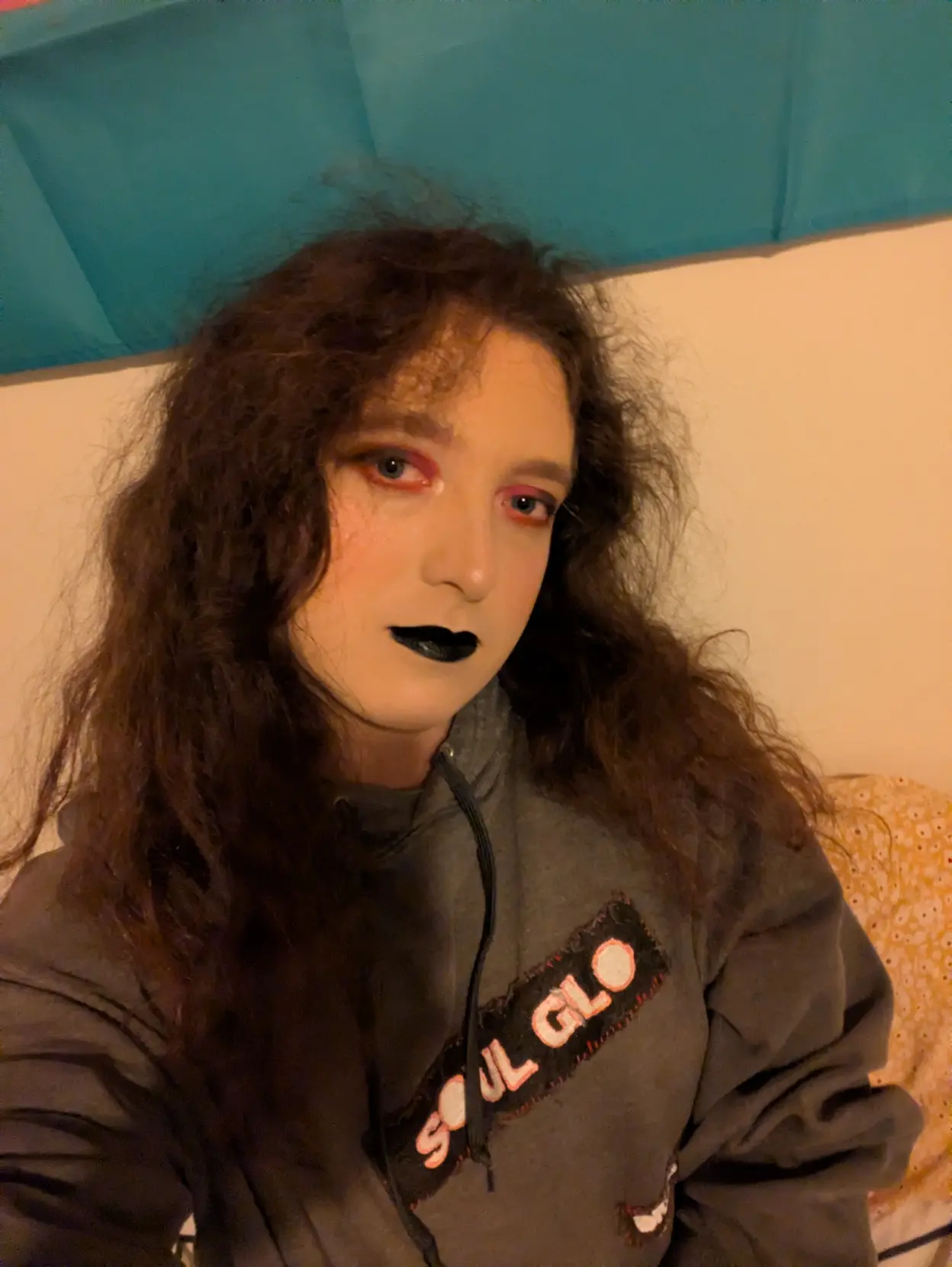 Pale transfem wears dramatic red and black makeup