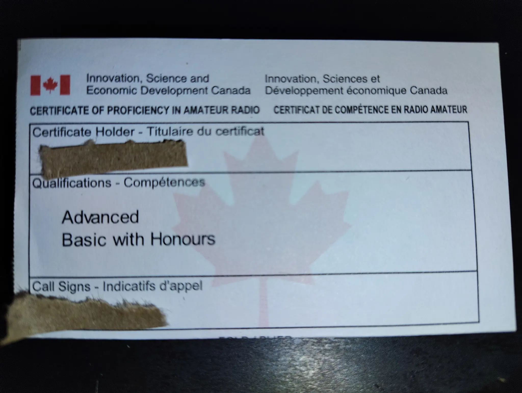 A certificate of proficiency in amateur radio from ISED Canada, with Advanced and Basic with Honours qualifications.